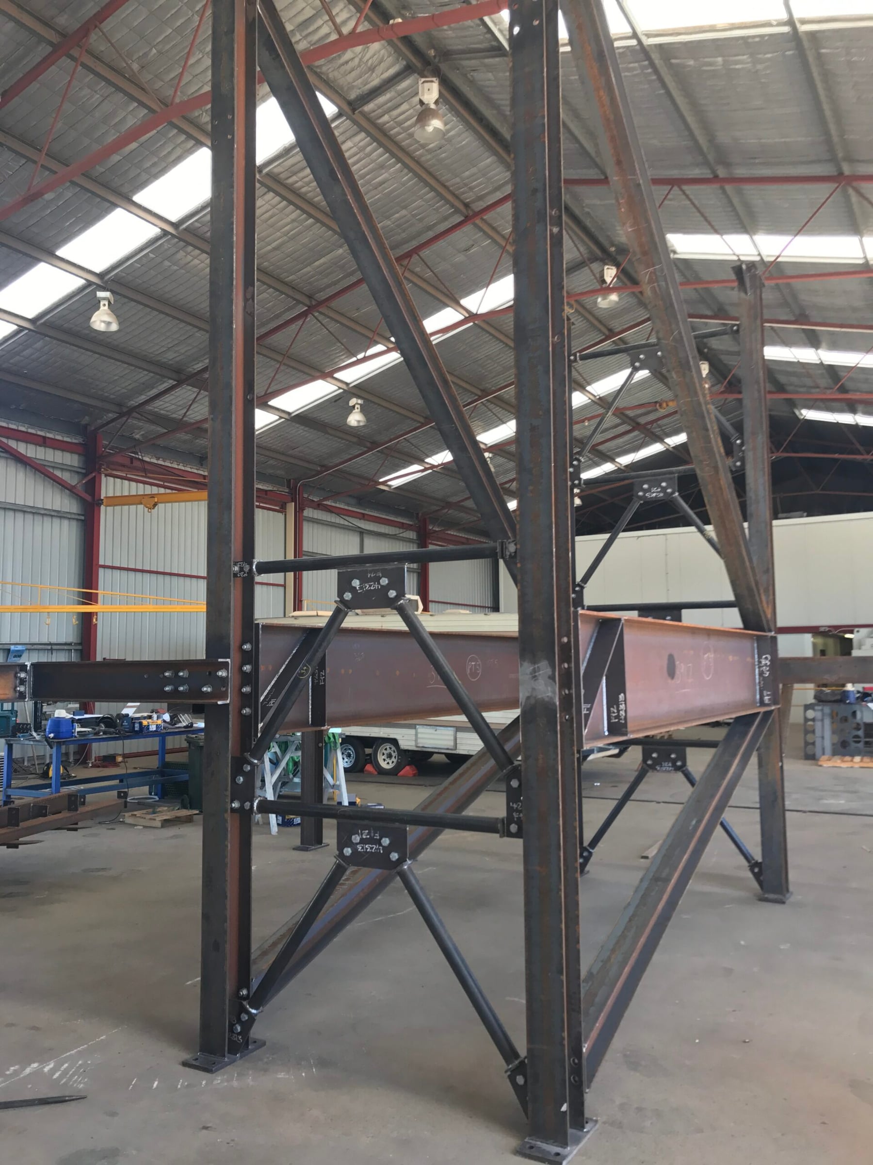 Structural steel columns and bracing during trial assembly in the workshop
