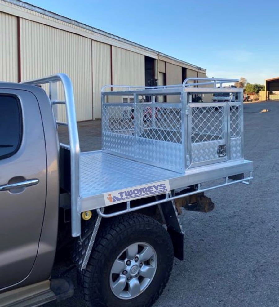 Galvanised ute tray with mesh cargo cage and headboard rack fitted to a dual cab ute outside the workshop